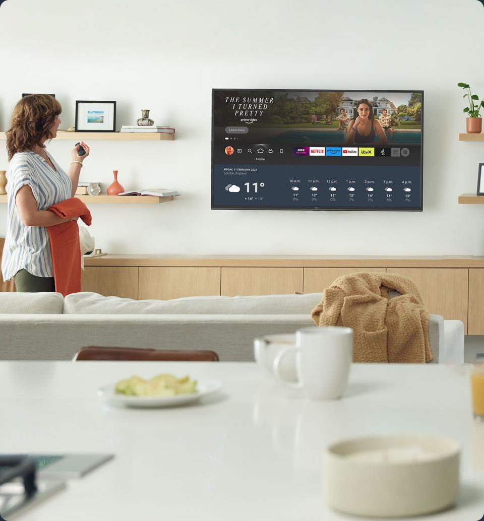 amazon fire tv series 2 on a white wall with a woman looking at it