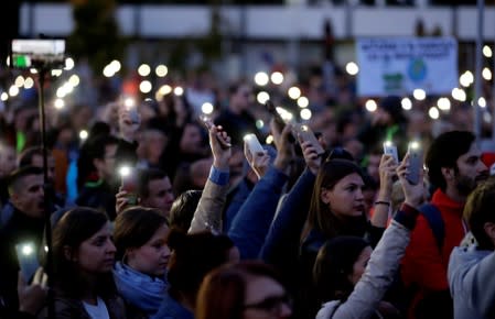 Demonstrators light up their mobile phones as they attend an anti-government protest rally in reaction to last year's killing of the investigative reporter Jan Kuciak and his fiancee Martina Kusnirova in Bratislava
