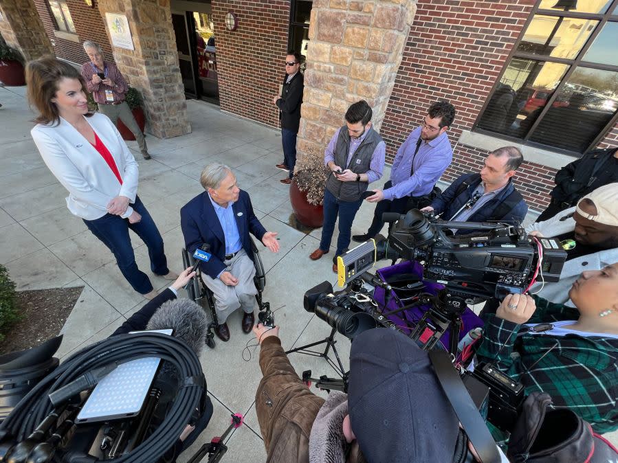 State Rep. Ellen Troxclair and Gov. Greg Abbott talk to reporters after they voted early together on Feb. 20. (KXAN photo/Todd Bailey)