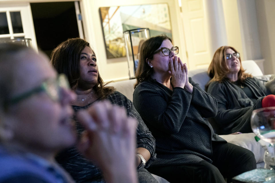 Supporters of Democratic presidential candidate Joe Biden, from left, Kimber Bishop-Yanke, Leslie Esters-Redwine, Lori Goldman and Mimi Miletic, react to election results at a watch party in Bloomfield Hills, Mich., Tuesday, Nov. 3, 2020. (AP Photo/David Goldman)