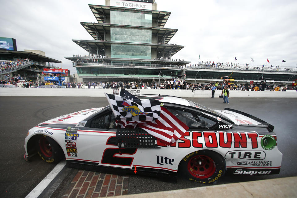 Brad Keselowski (2) celebrates after winning the NASCAR Brickyard 400 auto race at Indianapolis Motor Speedway in Indianapolis, Monday, Sept. 10, 2018. (AP Photo/Rob Baker)