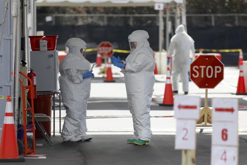 Medical University of South Carolina workers don protective suiting for coronavirus testing at the Citadel Mall parking lot in Charleston.