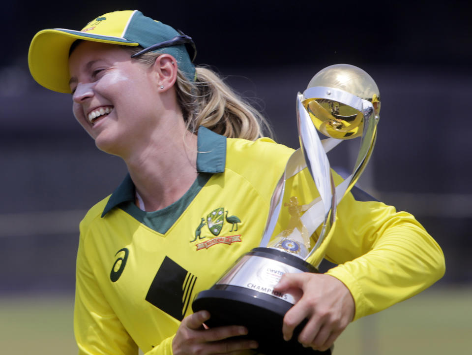 FILE - Australia's captain Meg Lanning with the trophy smiles after winning the final of Women's cricket T20 Triangular Series in Mumbai, India, Saturday, March. 31, 2018. Australia women's cricket captain Lanning has announced her international retirement after playing 241 matches — six tests, 103 one-day internationals and 132 Twenty20 matches.(AP Photo/Rajanish Kakade, File)