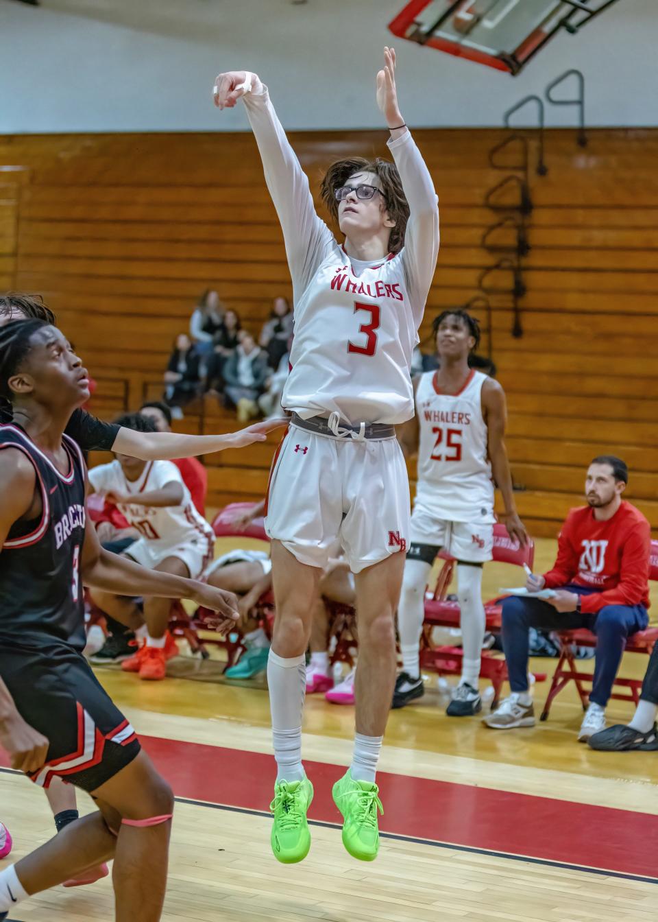 New Bedford guard Craig Baptista follows through as he buries a 3-pointer in front of a Brockton defender late in the fourth quarter on Friday evening.