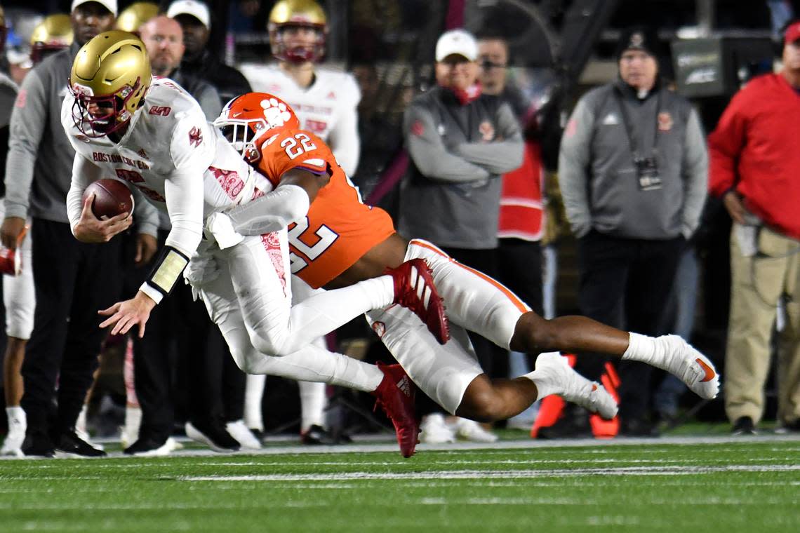 Clemson’s Trenton Simpson tackles Boston College quarterback Phil Jurkovec along the sideline during the first half of an NCAA college football game Saturday, Oct. 8, 2022, in Boston. (AP Photo/Mark Stockwell)