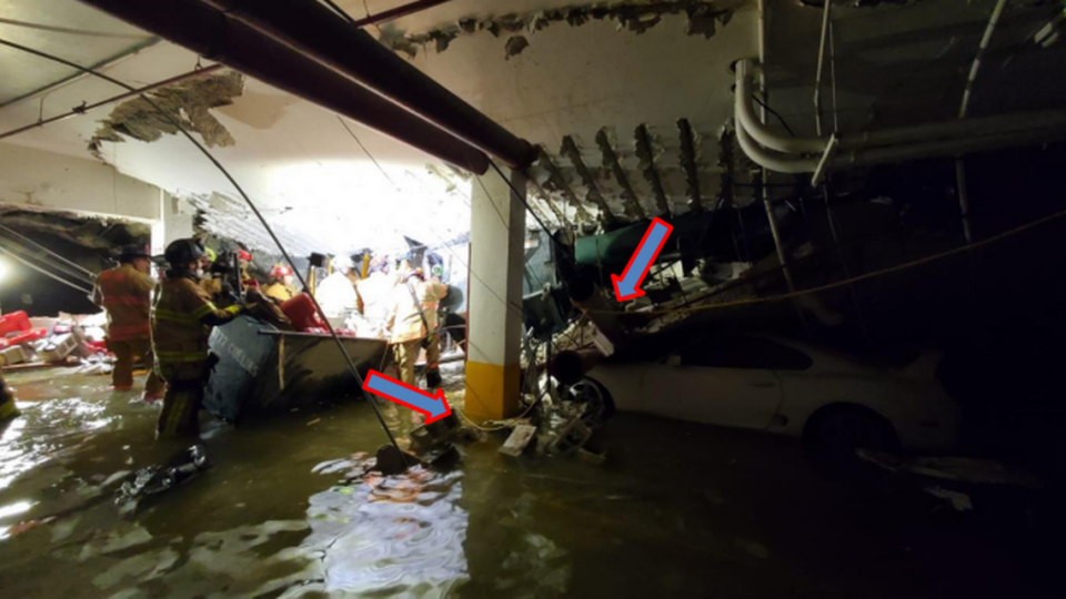 Undated image of rescue crews working in the garage of the collapsed Champlain Towers South. The arrows show how the crews arranged the electrical wires for recovery tools to avoid the wires becoming wet.