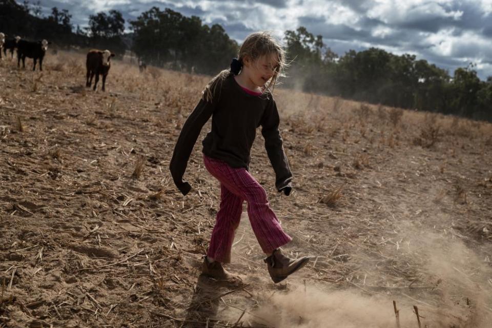 Heidi Taylor, 7, kicks up dust on the family farm outside Coonabarabran, in the Central Western region of New South Wales, Australia.