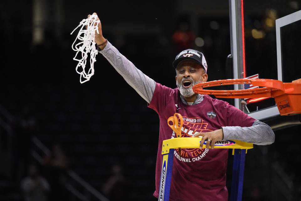 Virginia Tech head coach Kenny Brooks holds up the net as he celebrates a victory in an Elite 8 college basketball game of the NCAA Tournament against Ohio State, Monday, March 27, 2023, in Seattle. Virginia Tech won 84-74. (AP Photo/Caean Couto)