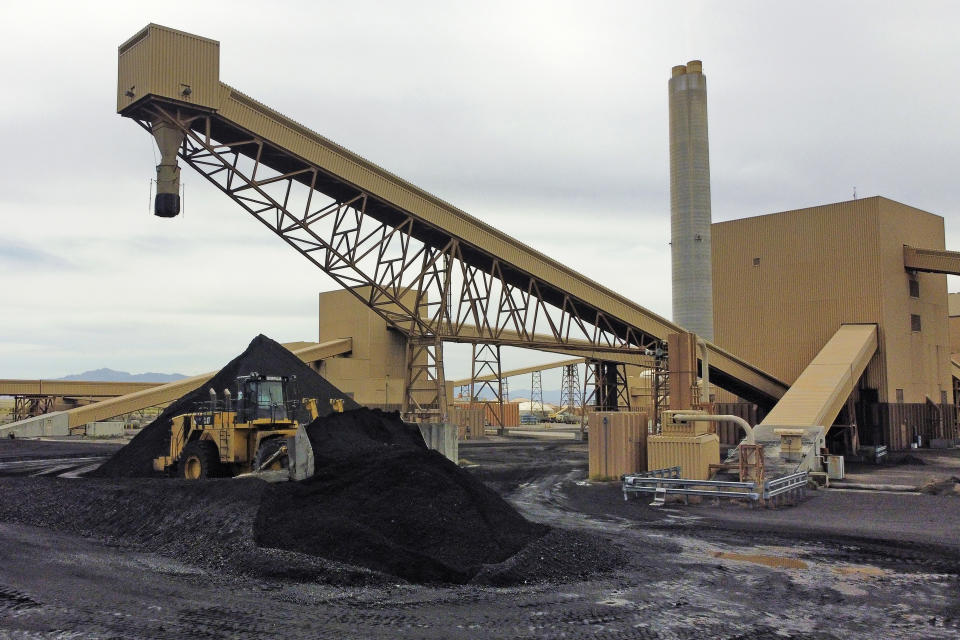 Piles of coal wait to be burned outside Intermountain Power Plant on Wednesday, June 22, 2022, in Delta, Utah. Developers in rural Utah who want to create big underground caverns to store hydrogen fuel won a $504 million loan guarantee this spring. They plan to convert the site of the 40-year-old coal power plant to cleanly-made hydrogen by 2045. (AP Photo/Rick Bowmer)