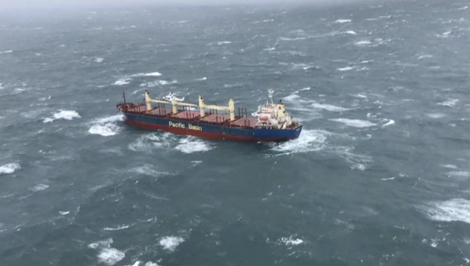 This image from a video released from Westpac Life Saver Rescue Helicopter, shows a stranded cargo ship off Wollongong, Australia Monday, July 4, 2022. A cargo ship that left the Australian port of Wollongong on Monday morning has lost power and is drifting at sea south of Sydney with 21 crew on board. According to local media, the ship is now anchored near the coast and a tugboat is on location to try and prevent it from getting closer to nearby cliffs and rocks. (Westpac Life Saver Rescue Helicopter via AP)