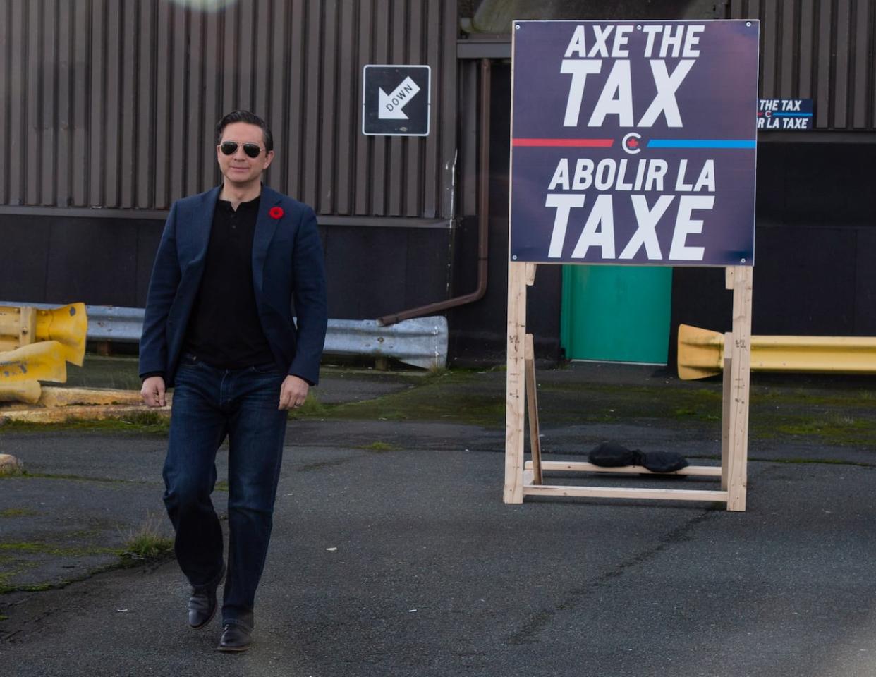 Conservative Leader Pierre Poilievre holds a press conference on his “Axe the Tax” message from the roof a parking garage in downtown St. John’s on Friday, Oct. 27, 2023. (Paul Daly/The Canadian Press - image credit)