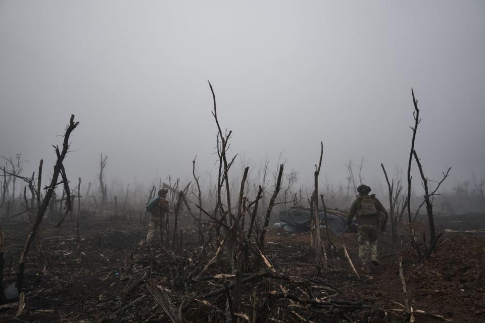 Photo for illustrative purposes. Two soldiers walk among destroyed trees in the morning fog, as the 10th Mountain Assault Brigade 'Edelveys' operate at the zero frontline with infantry holding fire at positions 100 meters below Russian positions, on Oct. 25, 2023 in the Bakhmut district of Ukraine. (Kostya Liberov/Libkos via Getty Images)
