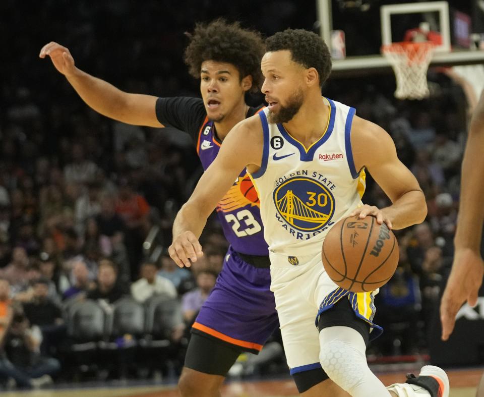 Oct 25, 2022; Phoenix, Ariz., U.S.;  Golden State Warriors guard Stephen Curry (30) is defended by Phoenix Suns forward Cameron Johnson (23) during the fourth quarter at Footprint Center.