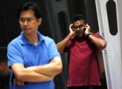 People, who said they believed they had relatives on Malaysia Airlines flight MH17, wait for more information about the crashed plane at Kuala Lumpur International Airport in Sepang July 18, 2014. The Malaysia Airlines Boeing 777 was brought down over eastern Ukraine on Thursday, killing all 295 people aboard and sharply raising the stakes in a conflict between Kiev and pro-Moscow rebels in which Russia and the West back opposing sides. REUTERS/Olivia Harris (MALAYSIA - Tags: TRANSPORT DISASTER CIVIL UNREST POLITICS)