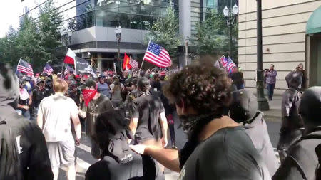Protesters of the right-wing group Patriot Prayer clash with protesters from anti-fascist groups during a demonstration in Portland, Oregon, U.S. June 30, 2018, in this still image taken from video from obtained from social media. Bryan Colombo/via REUTERS