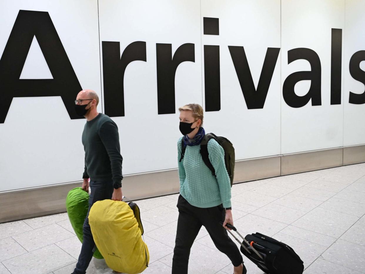 Passengers wear face masks as they arrive at London Heathrow Airport in west London on 28 January, 2020: Daniel Leal-Olivas/AFP via Getty Images