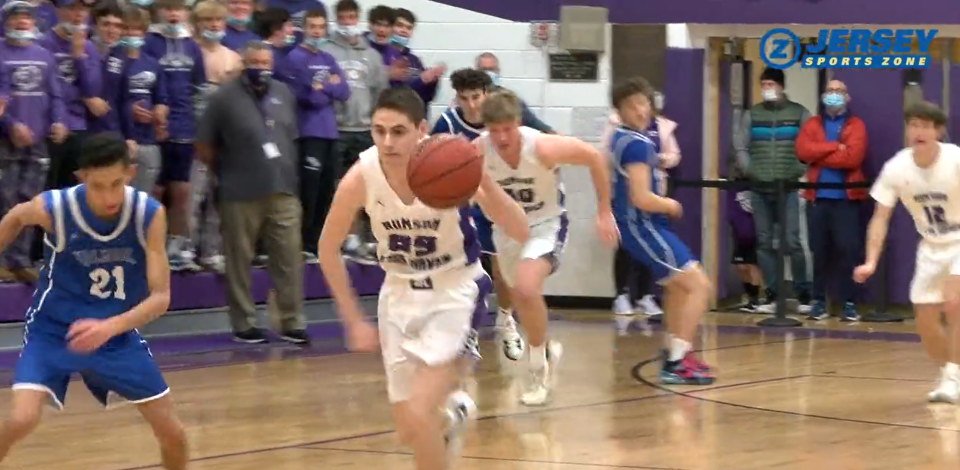 Rumson-Fair Haven's Matt Newman dribbles after taking the ball from Holmdel's Drew Pollock (No. 21).