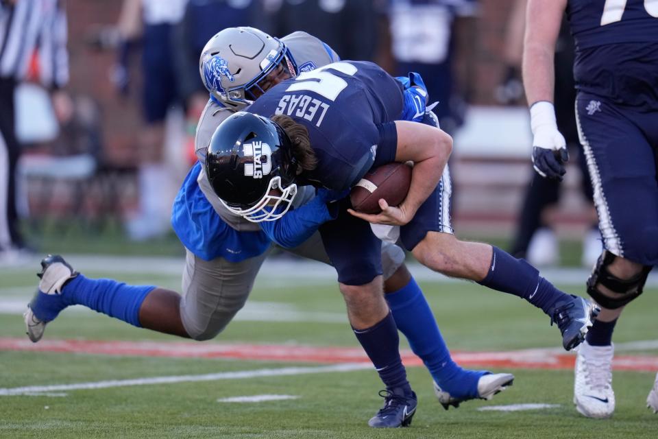 Utah State Aggies quarterback Cooper Legas (5) is sacked by Memphis Tigers defensive lineman James Stewart (92) during the second half in the 2022 First Responder Bowl at Gerald J. Ford Stadium on Dec. 27, 2022; Dallas, Texas, USA.