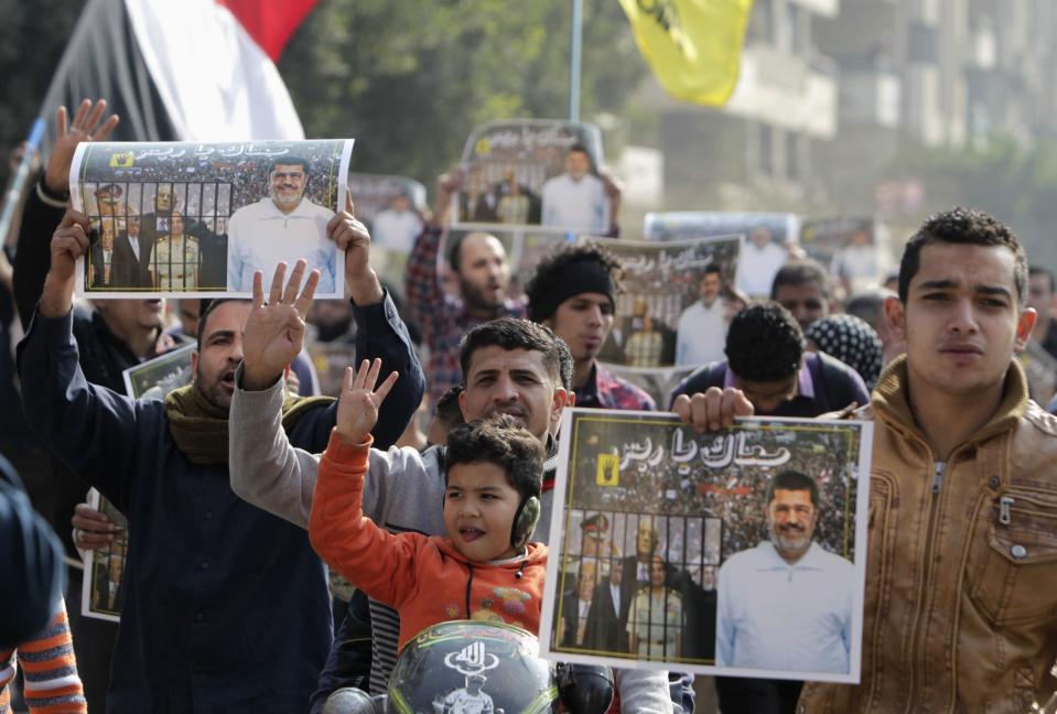 Supporters of the Muslim Brotherhood and ousted Egyptian President Mohamed Mursi protest against the military and interior ministry, while making the four-finger Rabaa gesture, at Nasr City district in Cairo January 3, 2014. The "Rabaa" or "four" gesture is in reference to the police clearing of the Rabaa al-Adawiya protest camp on August 14, 2013. (REUTERS/Mohamed Abd El Ghany)