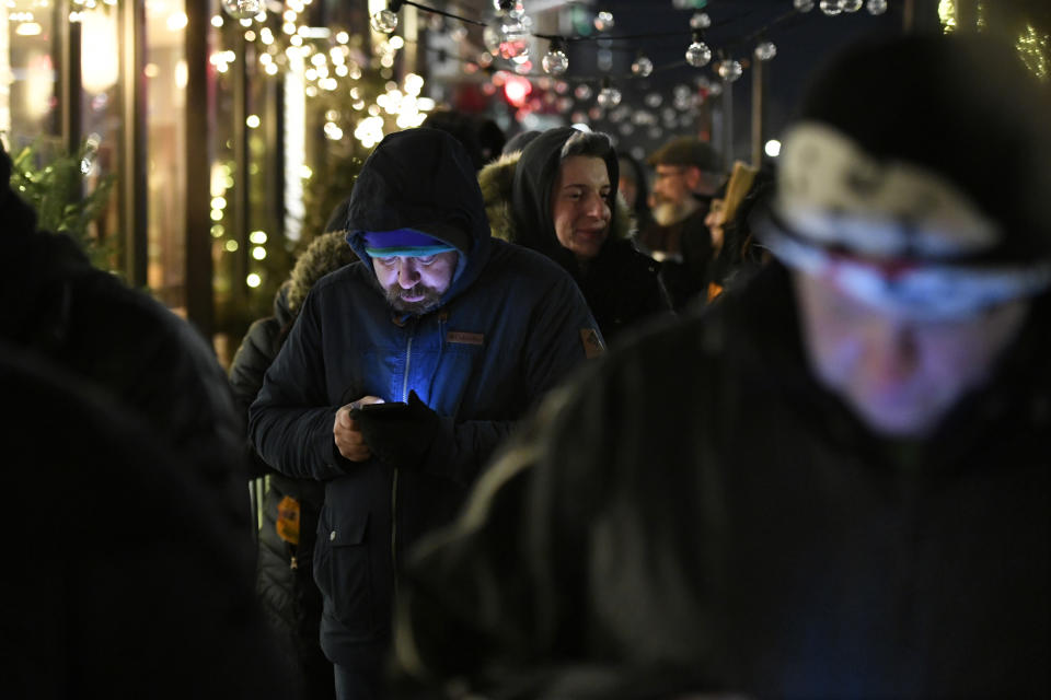 A long line of people brave the cold as they wait to be the first in Illinois to purchase recreational marijuana at Sunnyside dispensary Wednesday, Jan. 1, 2020, in Chicago. (AP Photo/Paul Beaty)