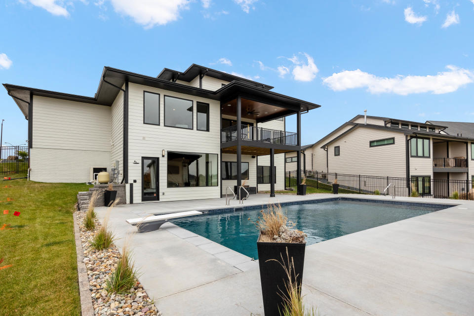This $1.5 million modern home in Ankeny features a heated pool, 6 bedrooms and killer views through two-story windows.
