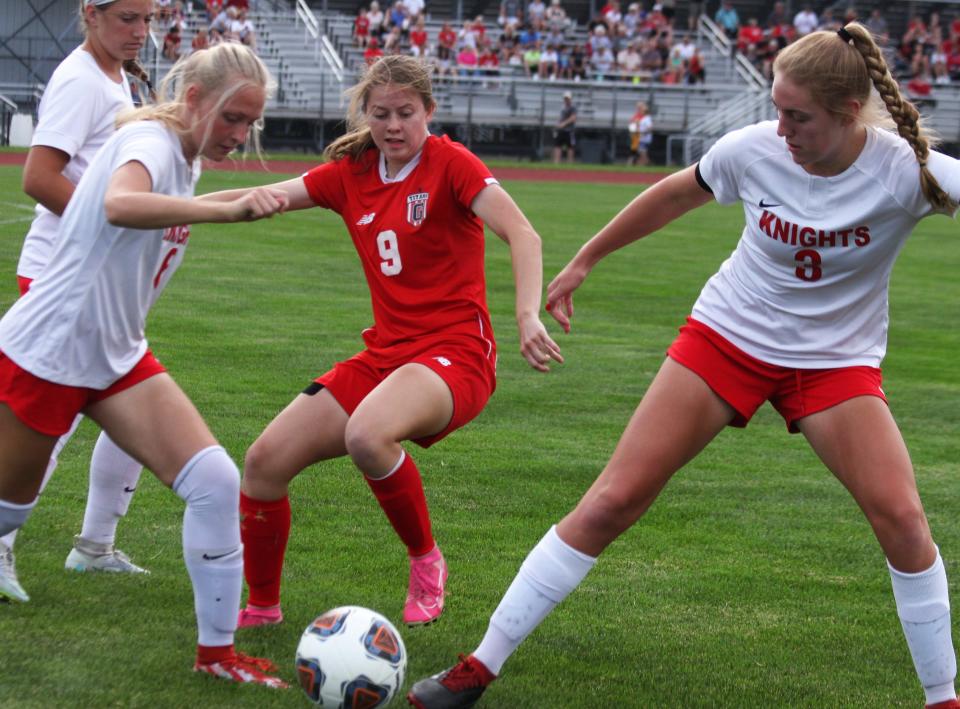 Chatham Glenwood senior midfielder Ella Gorrie (9) contends for the ball against Troy Triad in the Class 2A supersectional at the Glenwood Athletic Complex on Tuesday, May 31.