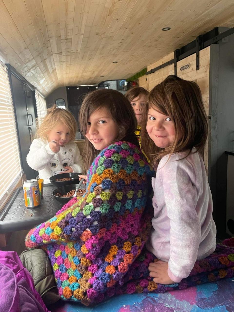 The couple's four daughters in their new home, a double decker bus. (SWNS)