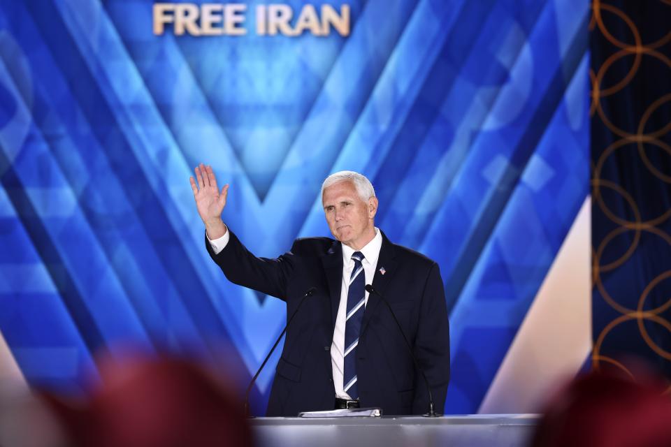 Former U.S. Vice President Mike Pence waves during his speech at the Iranian opposition headquarters in Albania, where up to 3,000 MEK members reside at Ashraf-3 camp in Manza town, about 30 kilometers (16 miles) west of Tirana, Albania, Thursday, June 23, 2022. (AP Photo/Franc Zhurda)
