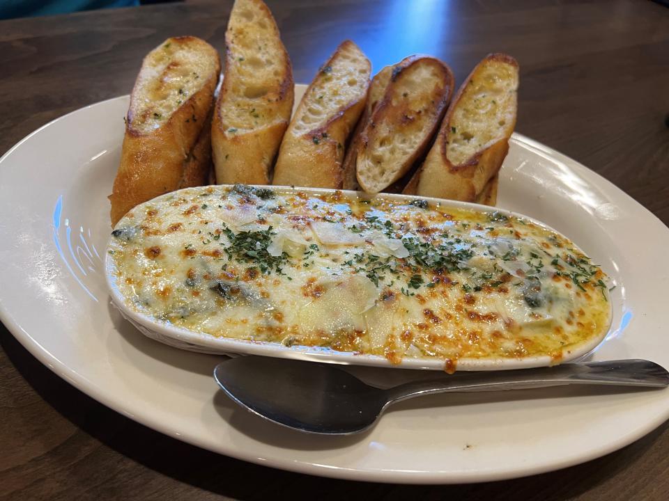 The crab and artichoke dip at Tavern Grill offers soft grilled hunks of bread on the side at Jordan Creek Town Center.