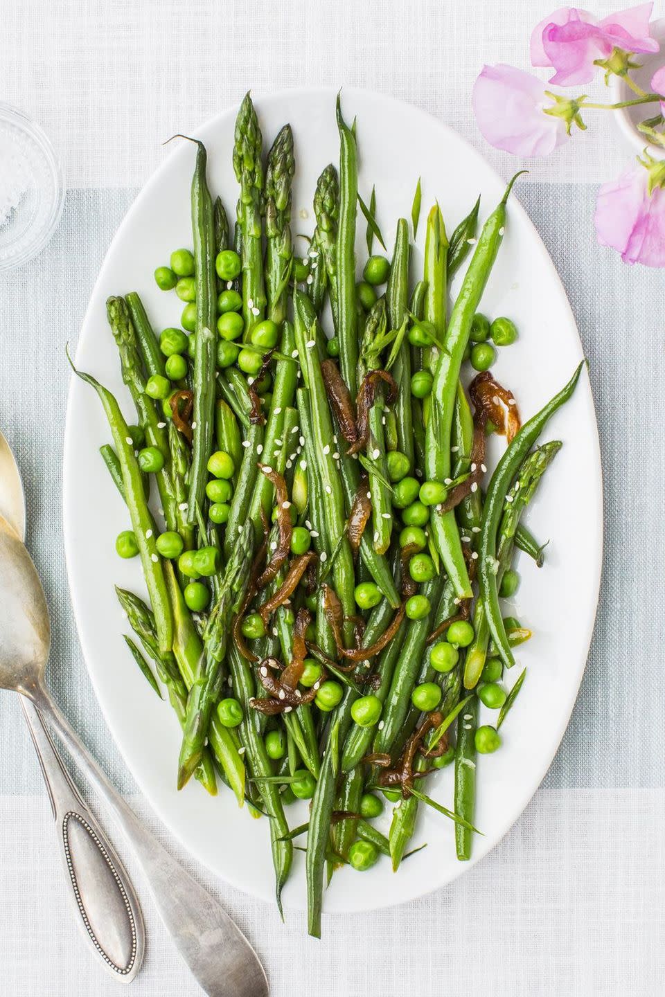 lemony asparagus, beans and peas on a white plate