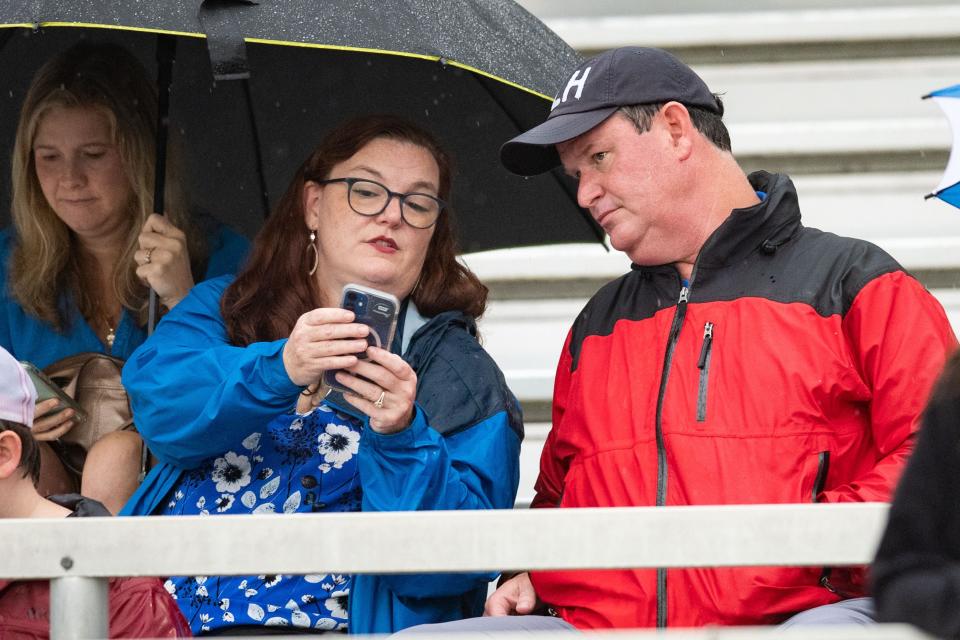 Virginia Dailey shows her husband Mayor John Dailey, who is running for reelection, live results as precincts close at the end of the primary election Tuesday, Aug. 23, 2022. Dailey attended a football game with his family as they watched his eldest son play. 