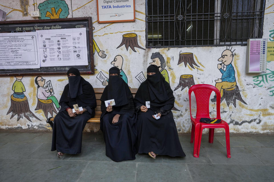FILE- Muslim women wait to cast their vote in a polling station during the fifth round of multi-phase national elections in Mumbai, India, Monday, May 20, 2024.(AP Photo/Rajanish Kakade, File)