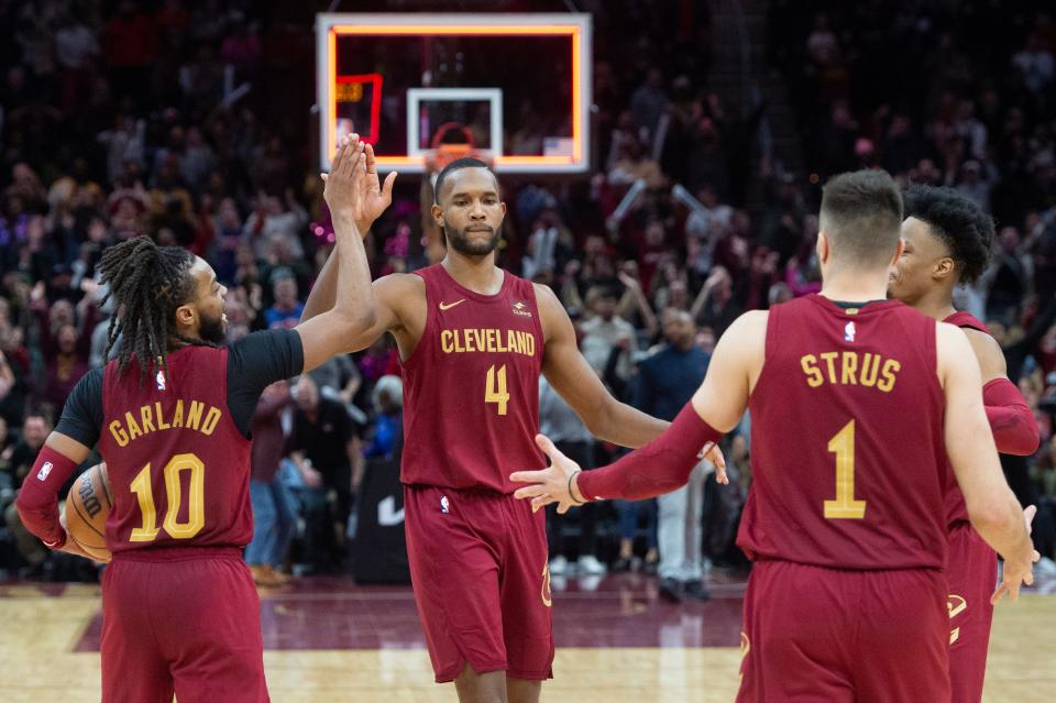 Cleveland Cavaliers' Evan Mobley (4) celebrates a win over the Chicago Bulls with Darius Garland (10) and Max Strus (1) at the end of the second half of an NBA basketball game in Cleveland, Wednesday, Feb. 14, 2024. (AP Photo/Phil Long)