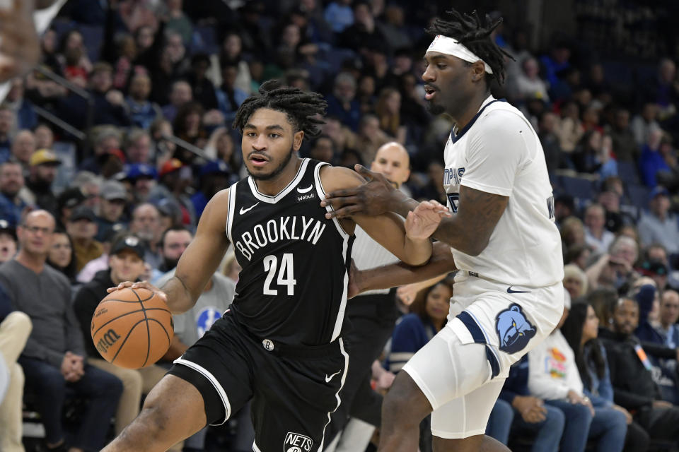 Brooklyn Nets guard Cam Thomas (24) handles the ball against Memphis Grizzlies guard Vince Williams Jr., right, in the first half of an NBA basketball game Monday, Feb. 26, 2024, in Memphis, Tenn. (AP Photo/Brandon Dill)