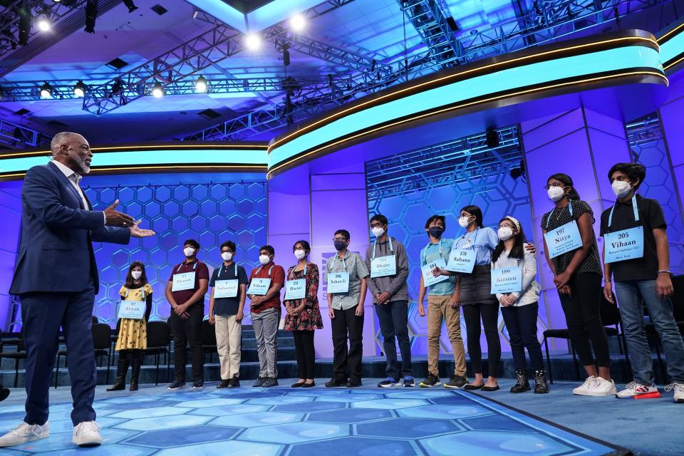 Actor LeVar Burton, left, gestures to the 12 finalists during the Scripps National Spelling Bee on Wednesday.