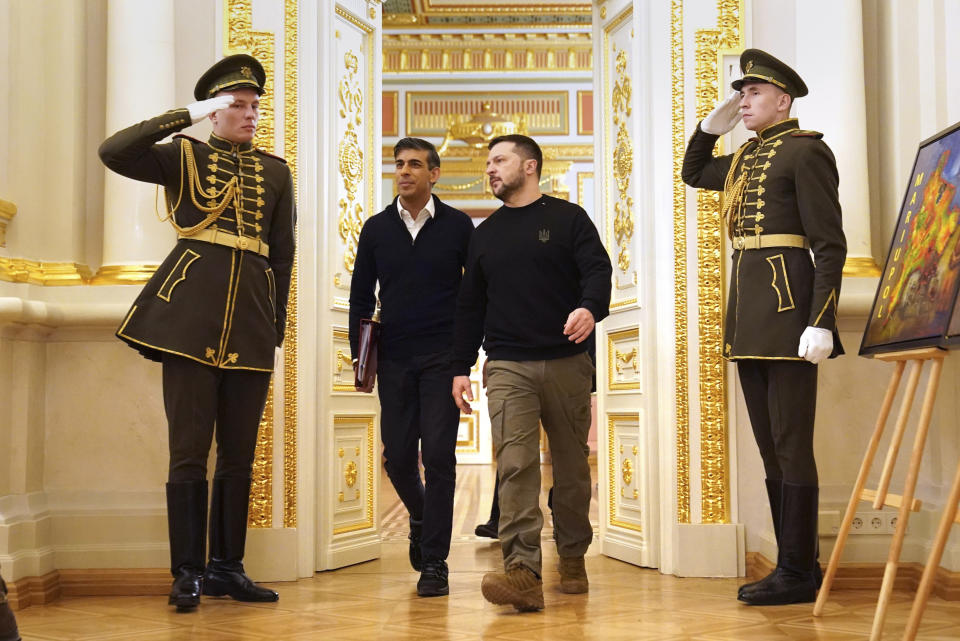 Britain's Prime Minister Rishi Sunak, center left, and Ukrainian President Volodymyr Zelenskyy arrive for a press conference at the Presidential Palace in Kyiv, Ukraine, Friday, Jan. 12, 2024. Sunak unveiled new military funding for Ukraine on Friday during a visit to Kyiv aimed at reassuring the country that the West is still providing support nearly 23 months after Russia’s invasion. (Stefan Rousseau/Pool via AP)