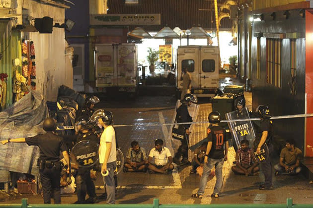Police detain men following a riot in Singapore's Little India district, late December 8, 2013. (REUTERS/Dennis Thong/Lianhe Zaobao)