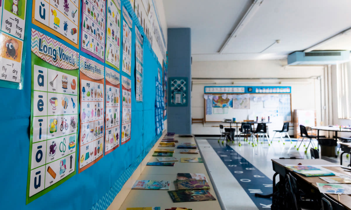 This is a photo of a classroom with a blue bulletin board.