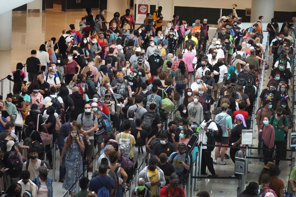 People stand in line to get through the TSA security checkpoint at Louis Armstrong New Orleans International Airport on Aug. 28, 2021, in New Orleans, La. Residents were evacuating the area as Hurricane Ida worked its way toward the Louisiana coastline with an expected landfall on Sunday afternoon.