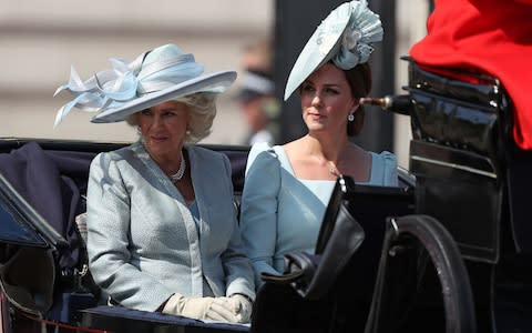 Britain's Camilla, Duchess of Cornwall (L) and Britain's Catherine, Duchess of Cambridge, travel in a carriage to Horseguards parade ahead of the Queen's Birthday Parade, 'Trooping the Colour', in London on June 9, 2018. The ceremony of Trooping the Colour is believed to have first been performed during the reign of King Charles II. In 1748, it was decided that the parade would be used to mark the official birthday of the Sovereign. More than 600 guardsmen and cavalry make up the parade, a celebration of the Sovereign's official birthday, although the Queen's actual birthday is on 21 April. - Credit: Daniel Leal-Olivas/AFP