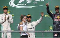 Formula One F1 - U.S. Grand Prix - Circuit of the Americas, Austin, Texas, U.S., 23/10/16. Mercedes' Lewis Hamilton of Britain celebrates his victory with a teammate as second placed finisher and teammate Nico Rosberg of Germany (L) and third placed Red Bull's Daniel Ricciardo of Australia cheer during the victory ceremony. REUTERS/Adrees Latif