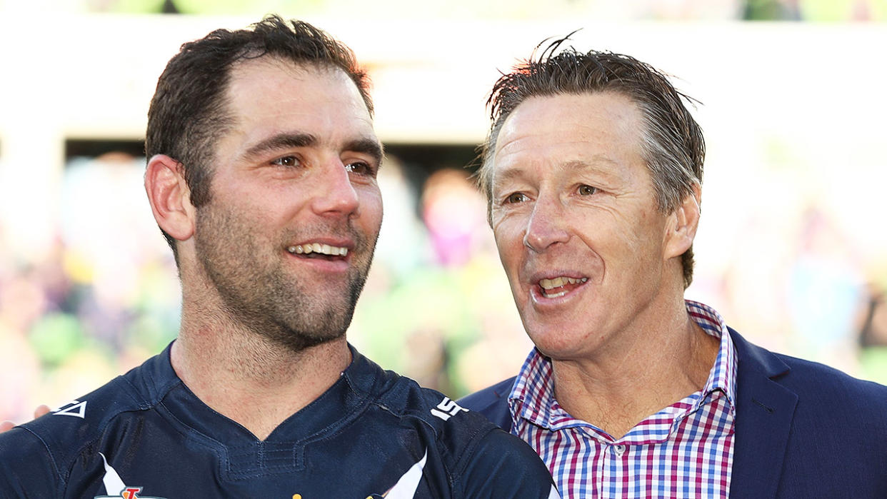 Cameron Smith (pictured left) celebrating with coach Craig Bellamy (pictured right).