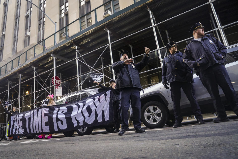 Demonstrators unveil a banner outside Manhattan's district attorney office, supporting a grand jury vote to indict former President Donald Trump, Thursday March 30, 2023, in New York. A Manhattan grand jury has voted to indict Donald Trump on charges involving payments made during the 2016 presidential campaign to silence claims of an extramarital sexual encounter, his lawyers said Thursday, producing the first criminal case against a former U.S. president and a jolt to Trump’s bid to retake the White House.(AP Photo/Bebeto Matthews)