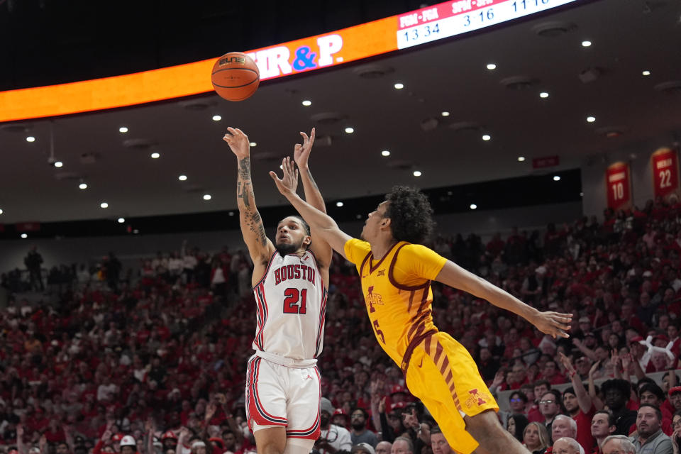 Houston's Emanuel Sharp (21) shoots as Iowa State's Curtis Jones (5) defends during the second half of an NCAA college basketball game Monday, Feb. 19, 2024, in Houston. Houston won 73-65. (AP Photo/David J. Phillip)