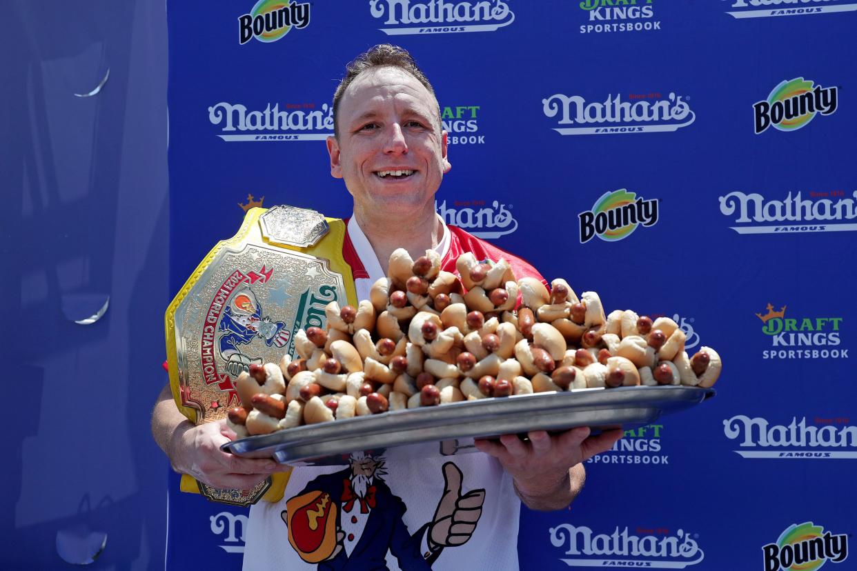 Competitive eater Joey Chestnut holds 76 hot dogs after winning the Nathan's Fourth of July Hot Dog Eating Contest in Coney Island on Sunday. 