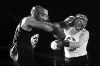 <p>Sgt. Russell Rodin and Sgt. Billy Gattis exchange punches in a battle of property clerks at the Brooklyn Smoker on Aug. 24, 2017. (Photo: Gordon Donovan/Yahoo News) </p>