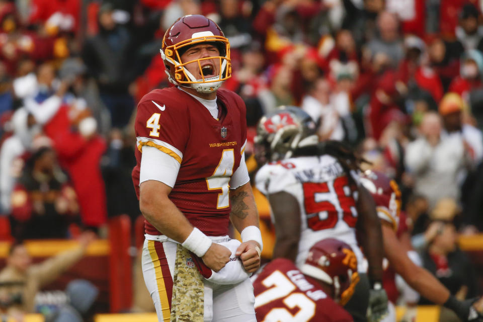 Washington Football Team quarterback Taylor Heinicke (4) celebrates after a Antonio Gibson touchdown in the fourth quarter of an NFL football game against the Tampa Bay Buccaneers, Sunday, Nov. 14, 2021, in Landover, Md. (Shaban Athuman/Richmond Times-Dispatch via AP)