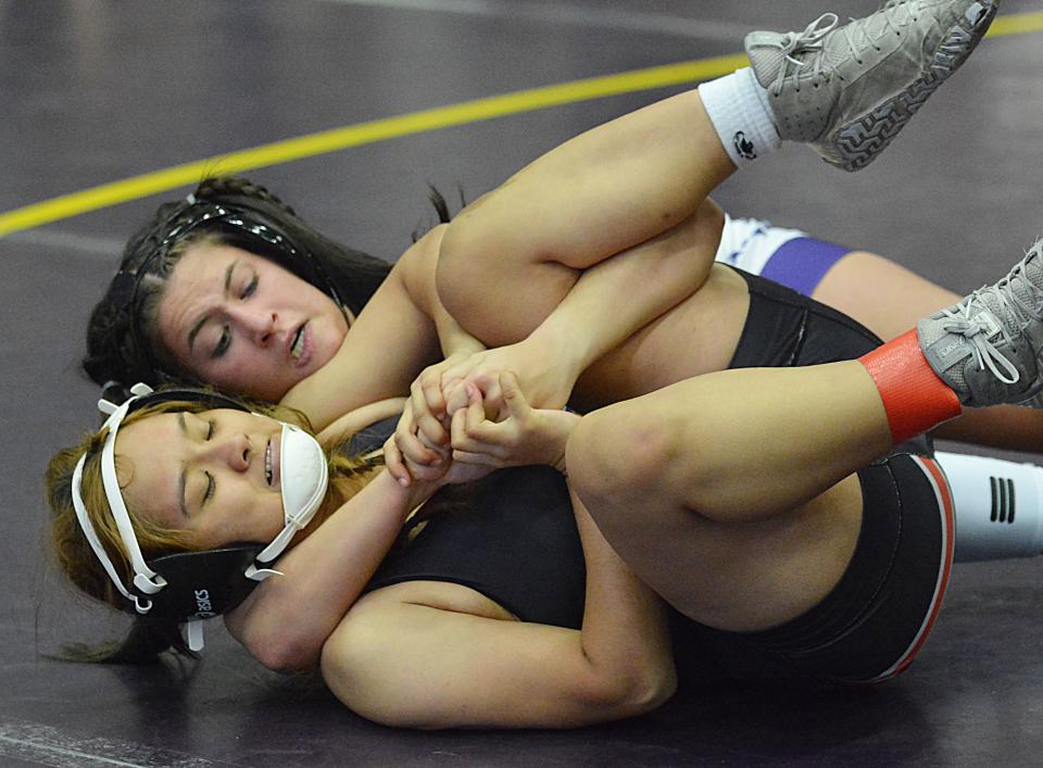 Watertown's Katelyn Yexley pins Huron's Kmui Paw during their 138-pound girls match in the Marv Sherrill Dual wrestling tournament on Saturday, Dec. 2, 2023 in the Watertown Civic Arena.