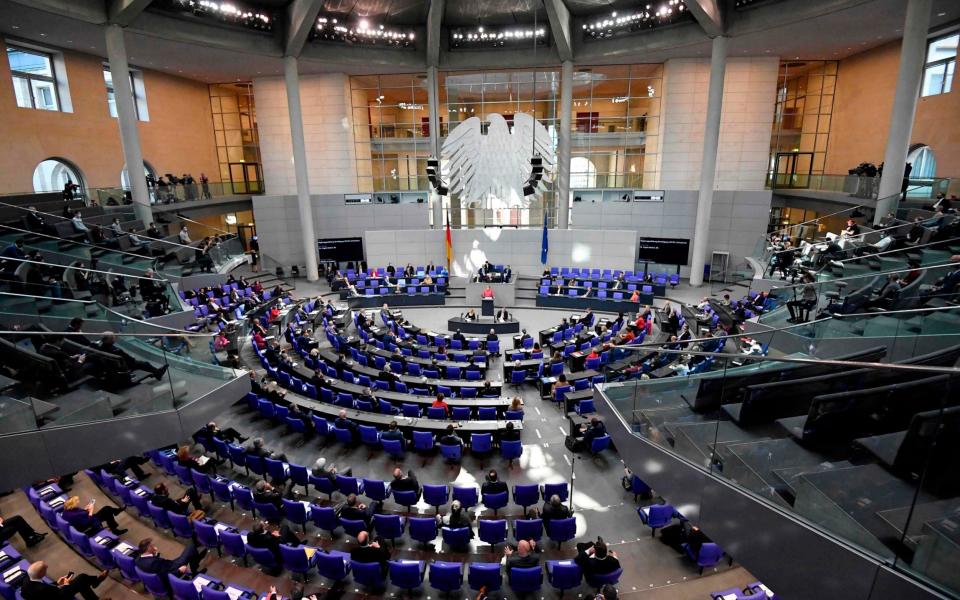 Angela Merkel delivers her speech in the Bundestag - Tobias Schwarz/AFP via Getty Images