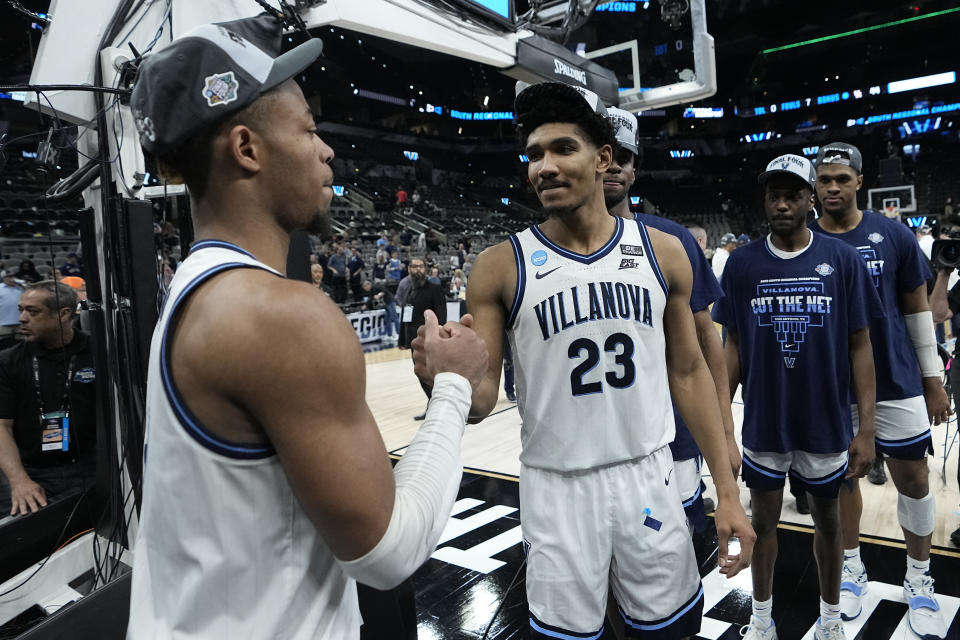 Villanova forward Jermaine Samuels leaves the court with guard Justin Moore after their win against Houston during a college basketball game in the Elite Eight round of the NCAA tournament on Saturday, March 26, 2022, in San Antonio. (AP Photo/David J. Phillip)